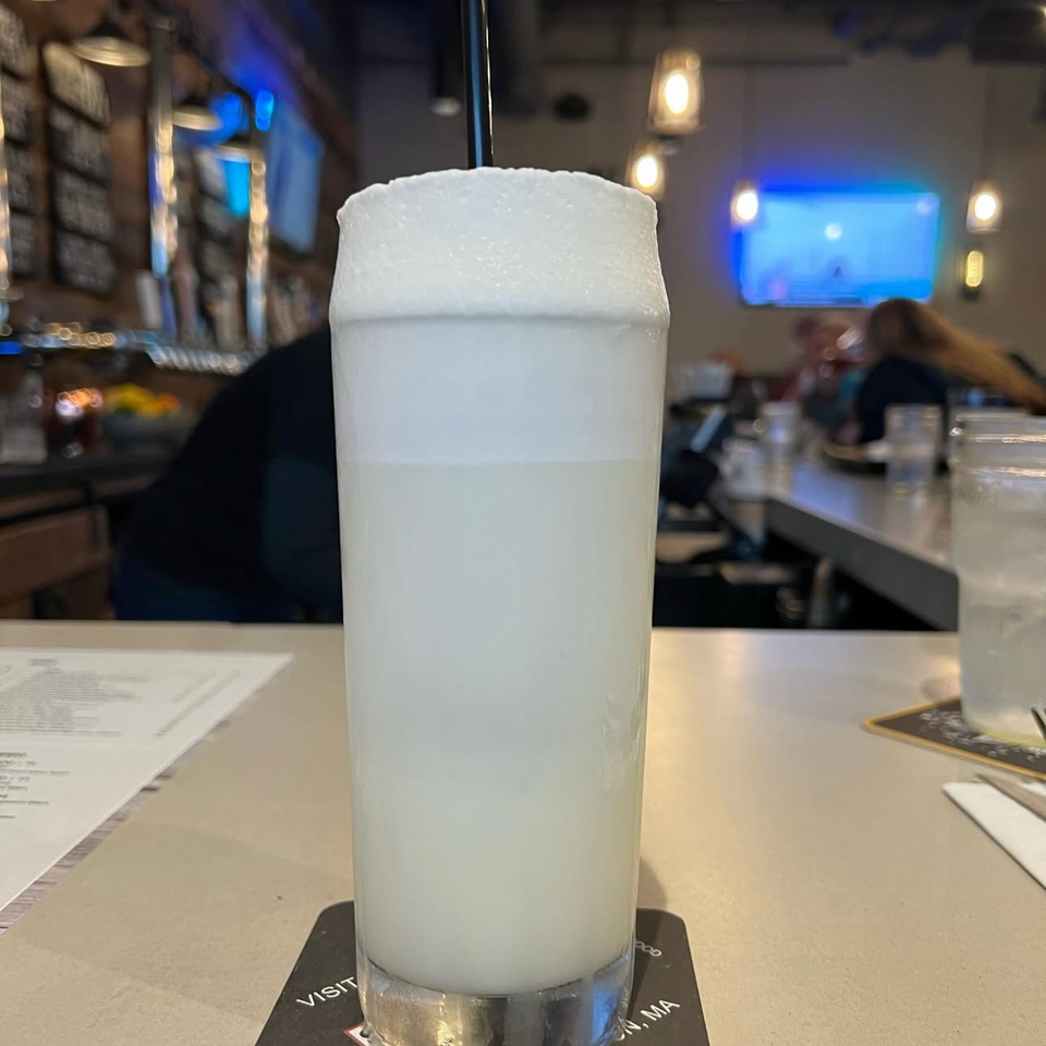 Tall frothy cocktail at The SHED bar