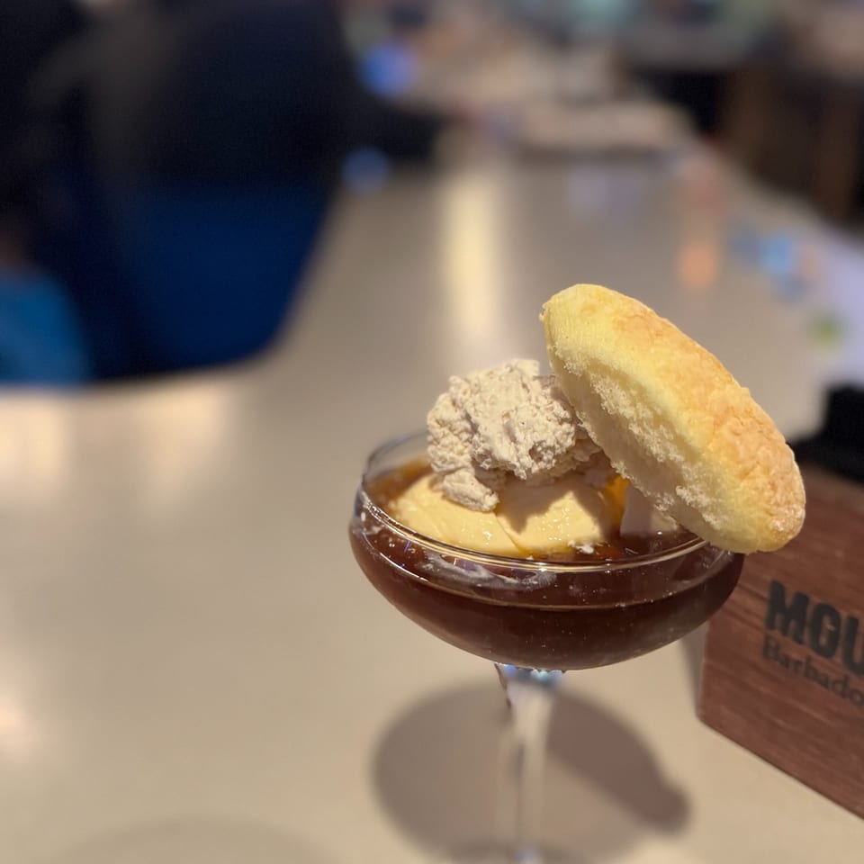 Cocktail topped with cream and a cookie at The SHED